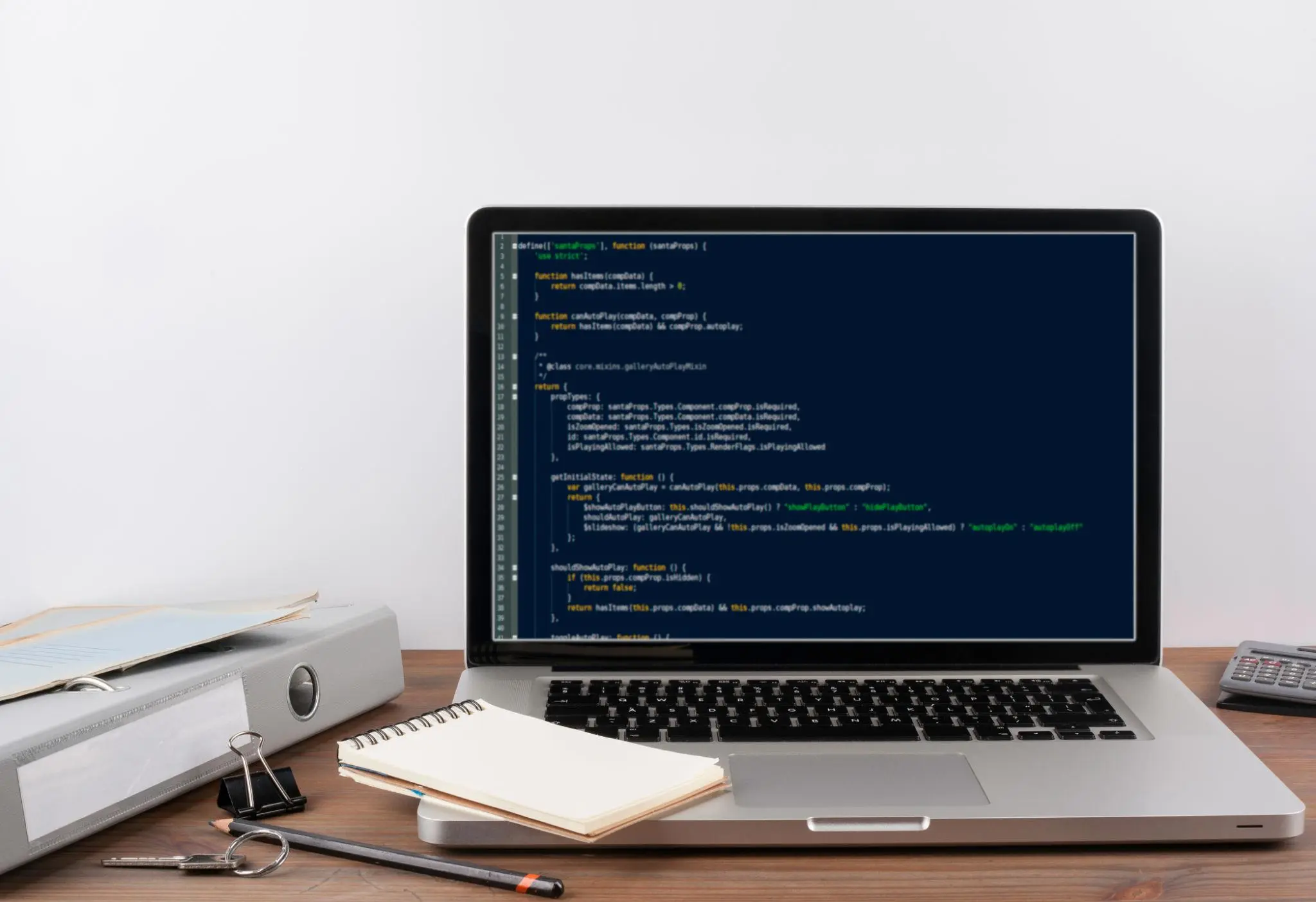 Developer workspace with laptop displaying code.