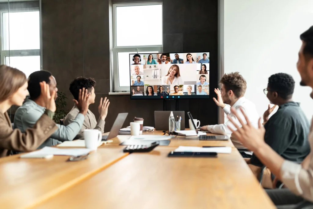 Employees collaborating through digital communication and video conferencing tools.